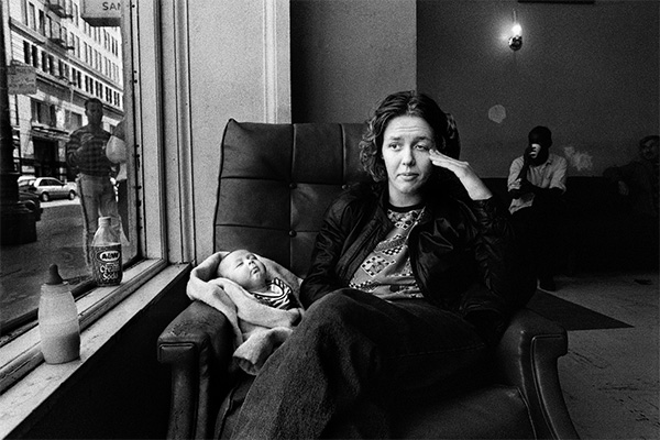 Women sits with her baby looking stressed