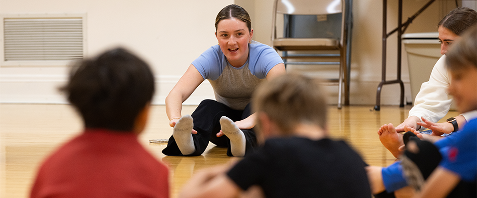 Teacher showing students how to stretch