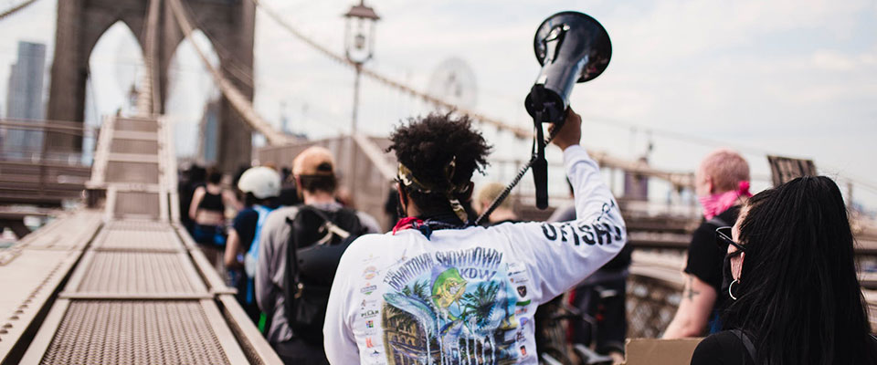 person with a megaphone on a bridge