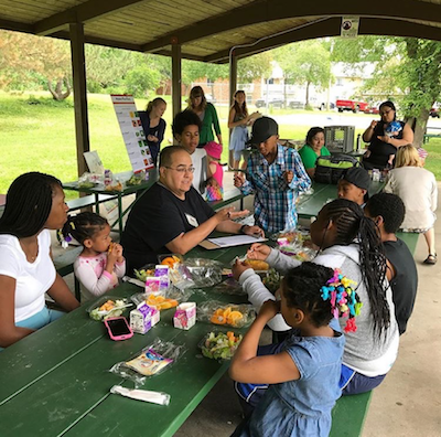 Anthony Hernandez interviewing people at a park