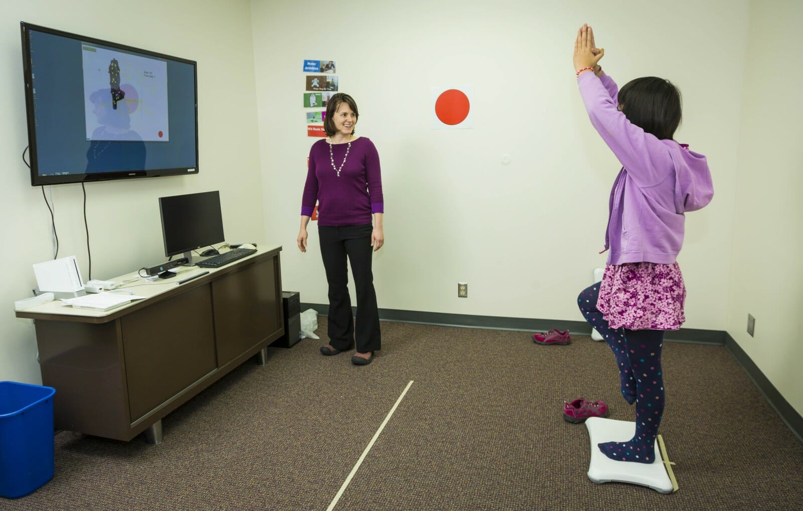 Brittany Travers with a study participant during a training session for a video game that helps improve balance in autistic teenagers.