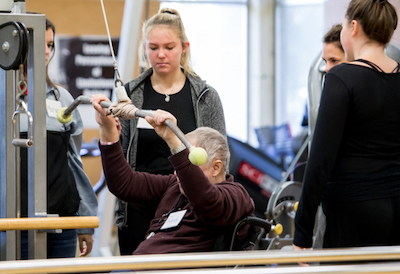 Students work with clients of the Adapted Fitness program