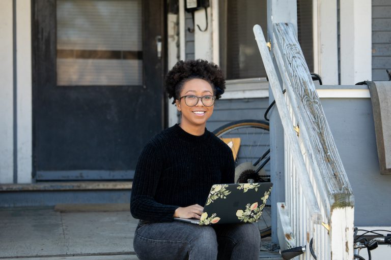 Bri’Anna Collins, a doctoral student in the Department of Educational Psychology’s School Psychology program, works from her porch after UW–Madison shifts to online learning due to the COVID-19 pandemic.
