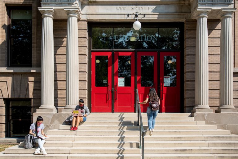three uw-madison students on the steps of the education building.