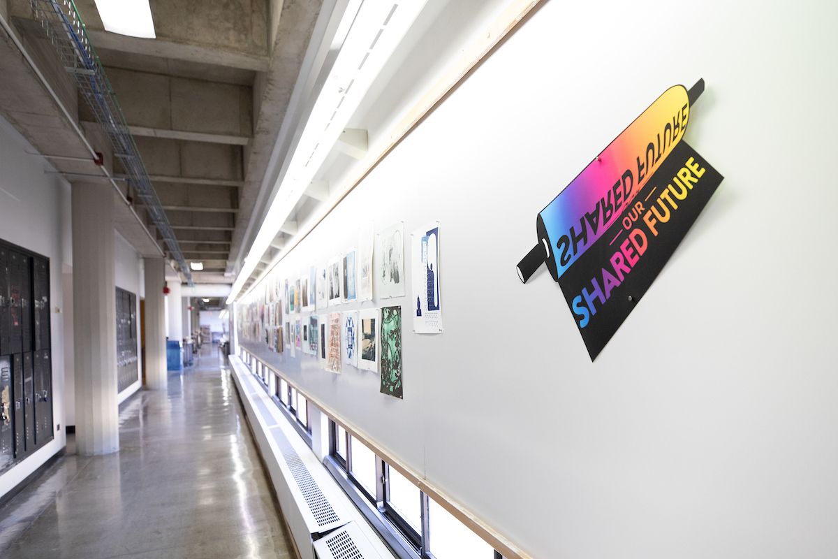 Hallway of Humanities Building lined with themed portfolios