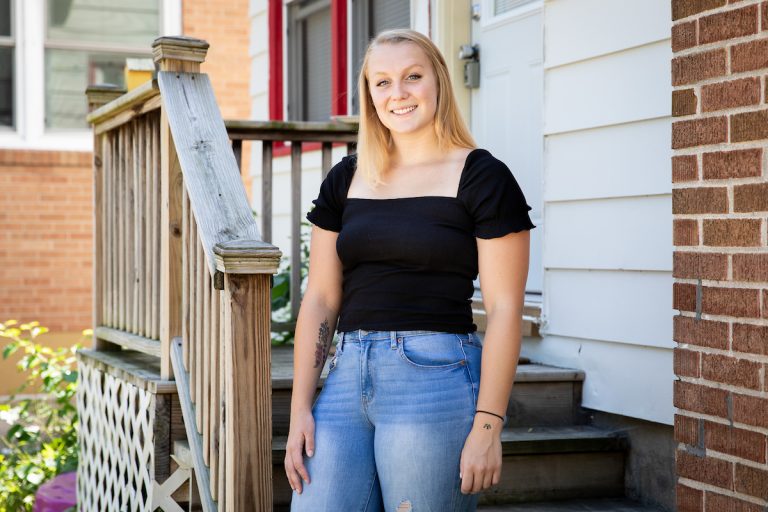 Student Kara Grajkowski stands near her porch
