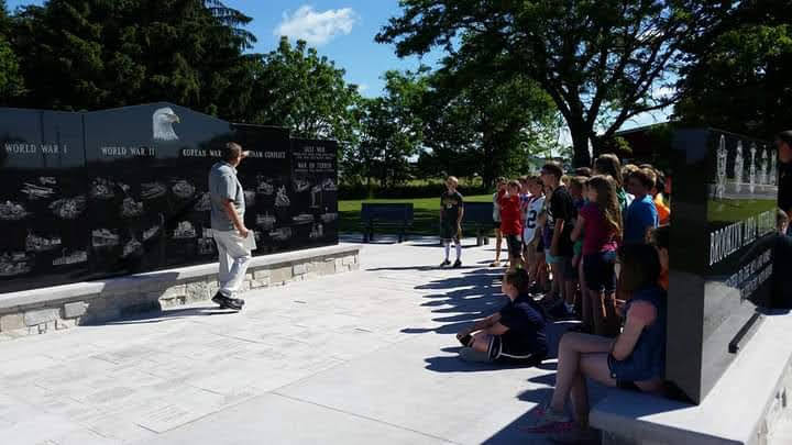 Dale Schulz speaking with students during a veterans tour.