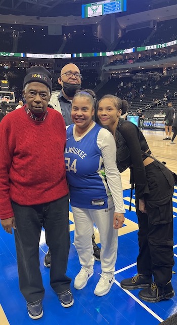 Carl Grant poses for a photo with his family.