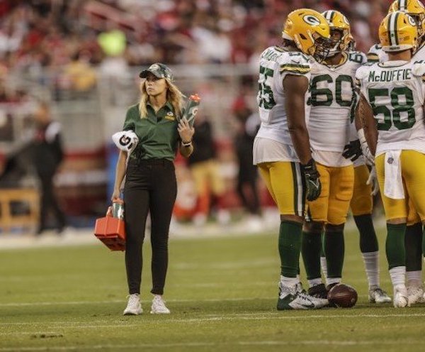 Erin Roberge on field during a break in play of a Packers game.