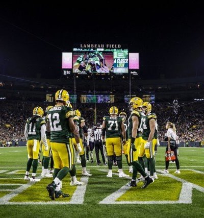 Erin Roberge on Lambeau field with players