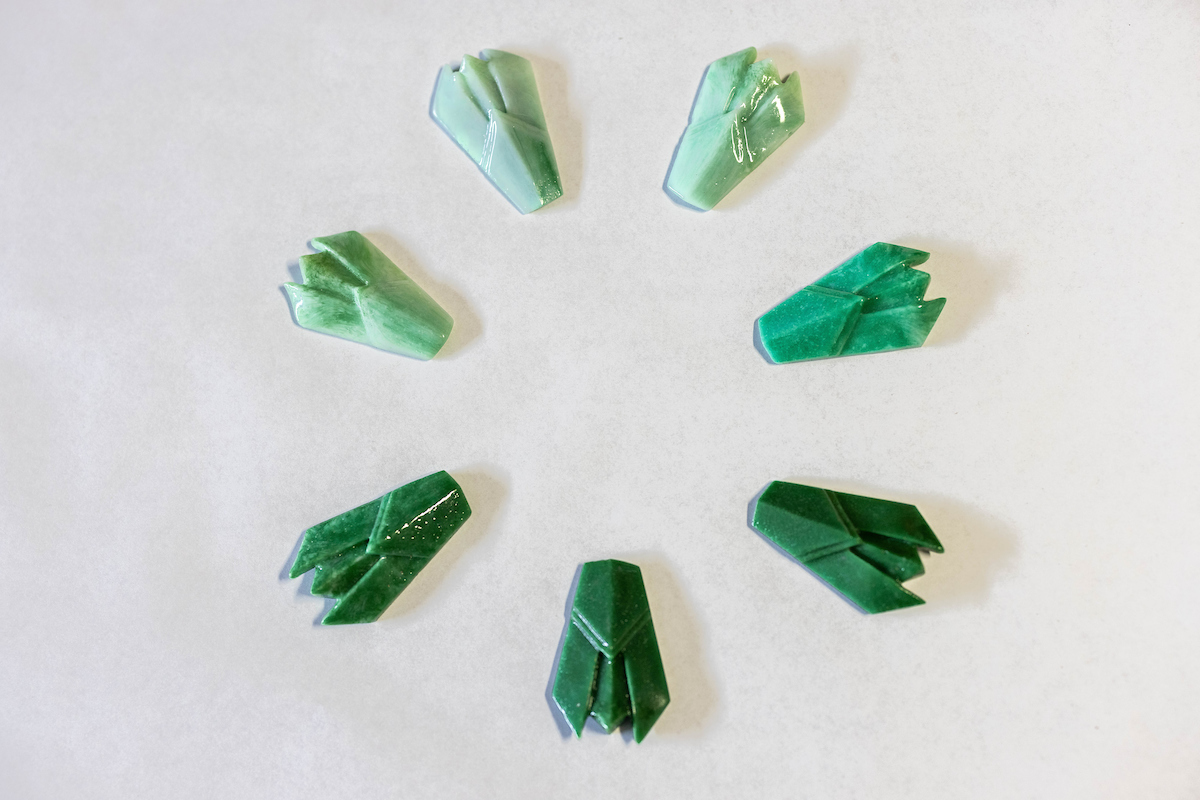 Seven glass cicadas in shades of jade green