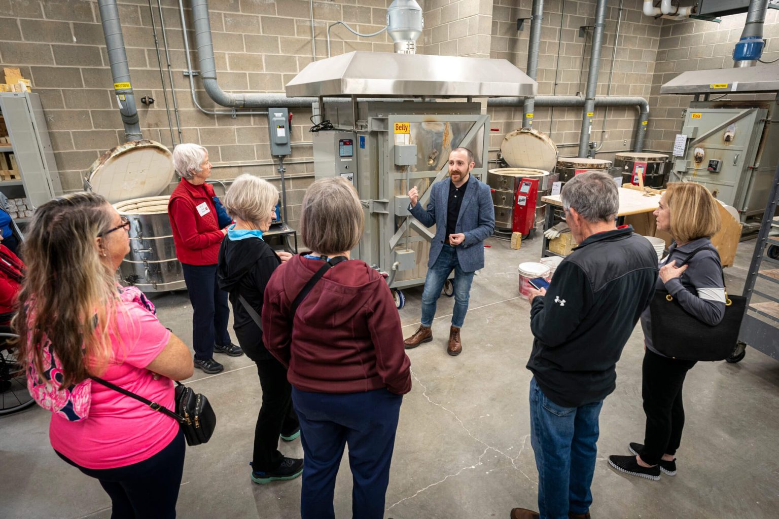 Matthew Mauk shows a tour group around the ceramics lab’s kiln room