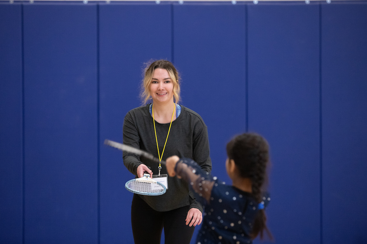 Taylor Olson plays with student