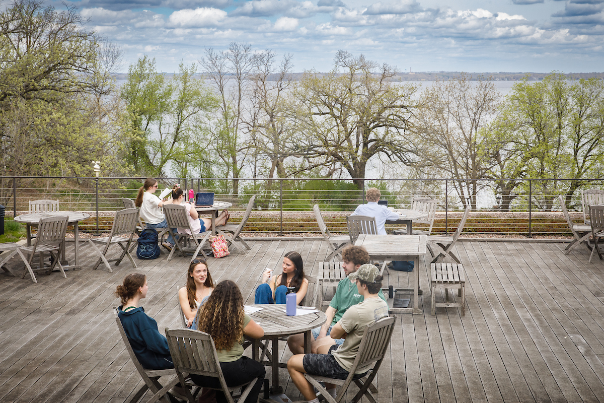 students eating lunch on a deck