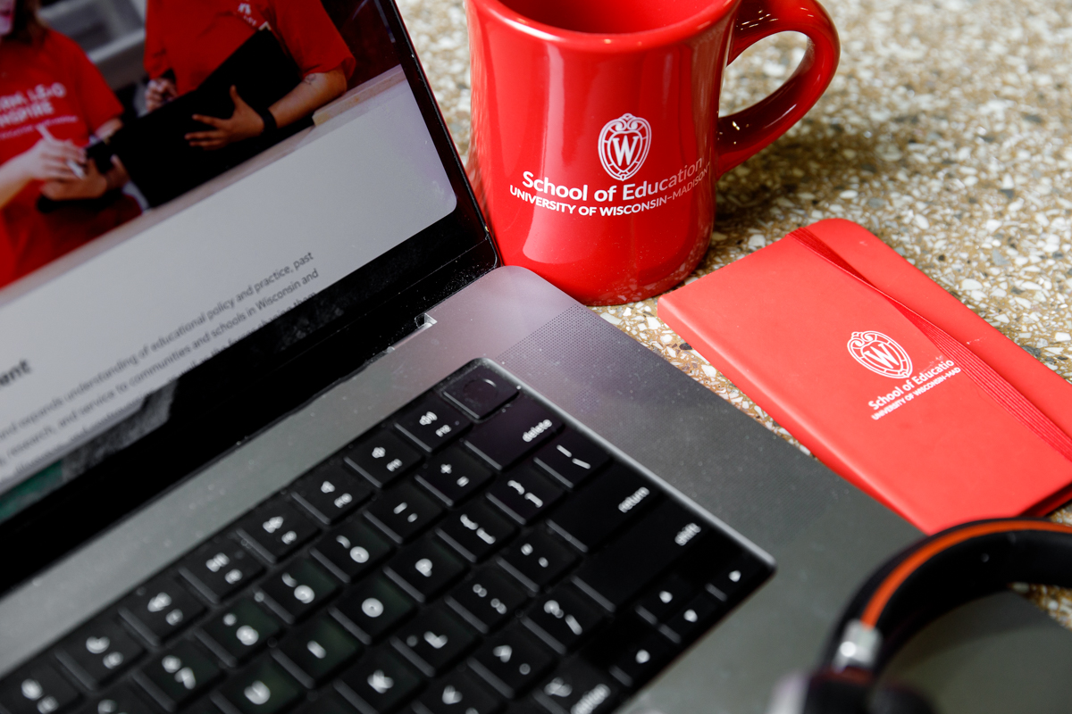 laptop, coffee cup, and notebook