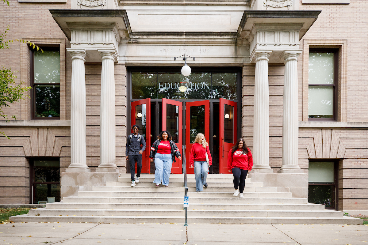 students walking out the doors of the uw school of education building