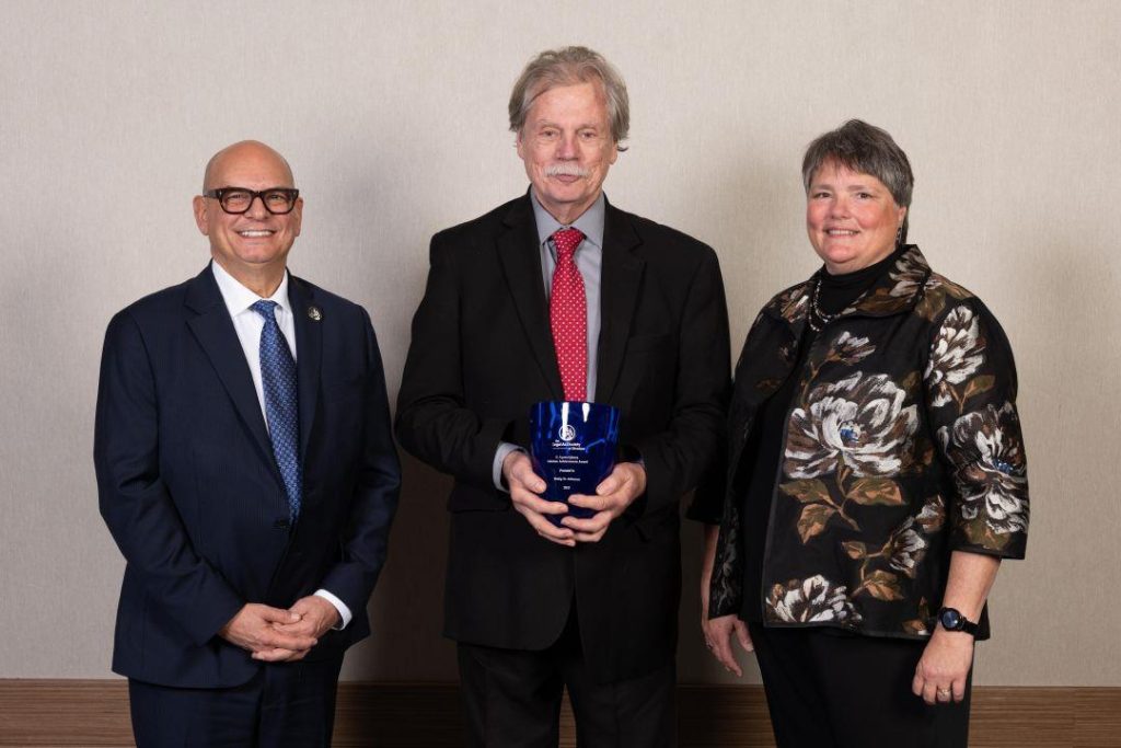 Philip Althouse (center) with Legal Aid board president Harlin Adelman and executive director Colleen Cotter