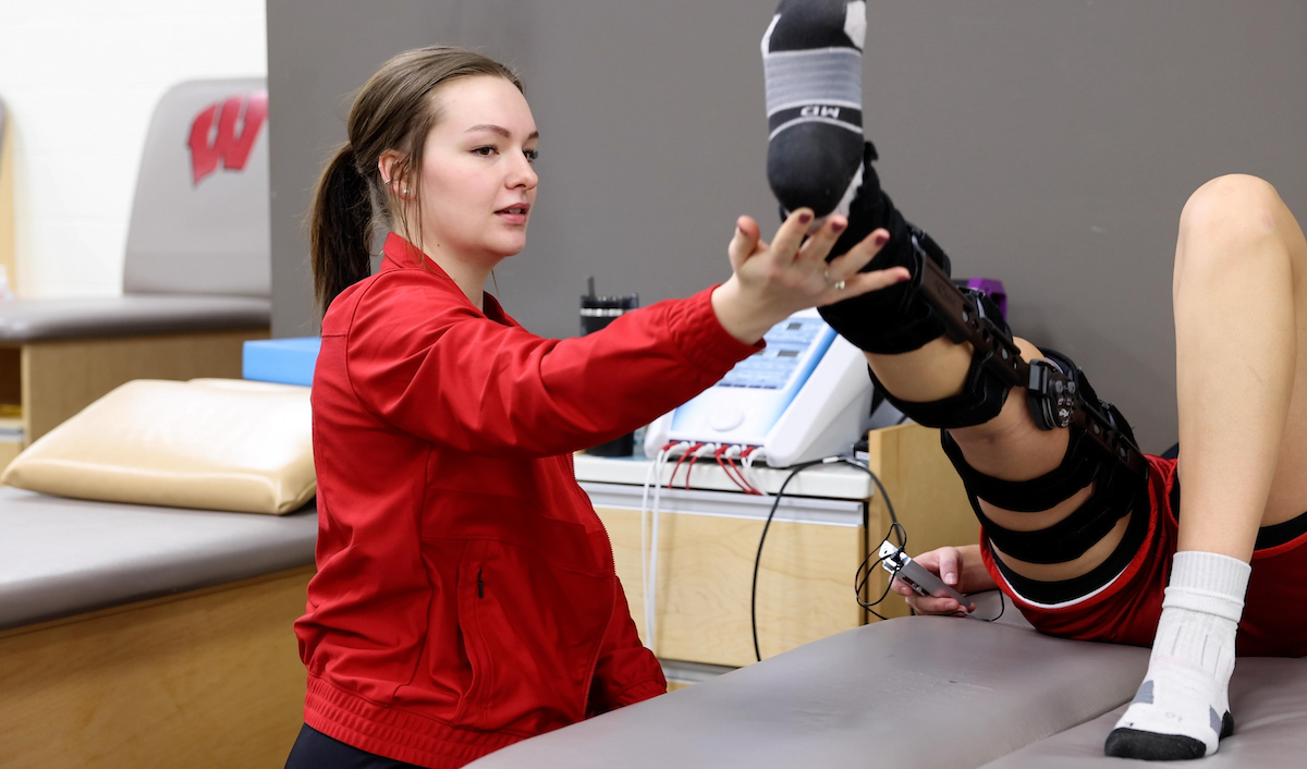 athletic training student works with an athlete