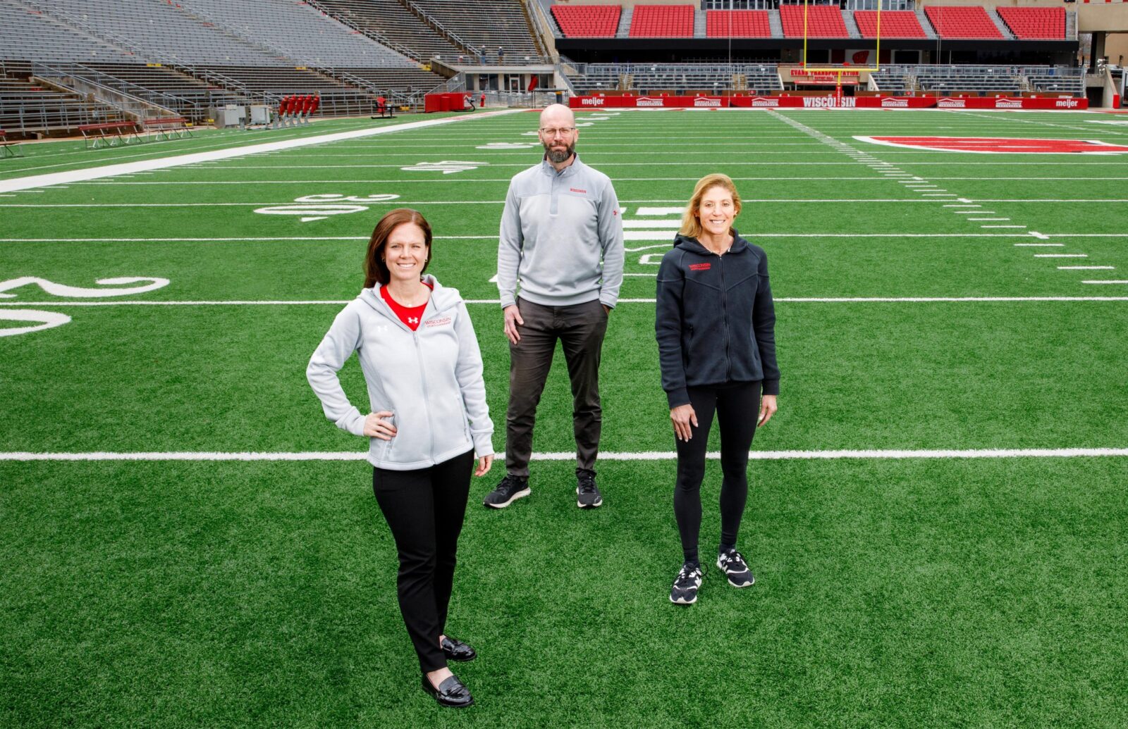 The three BIOS leaders stand on a football field