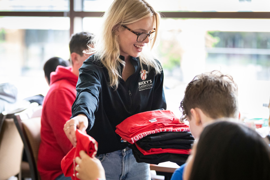 Handing out buckys classroom merch