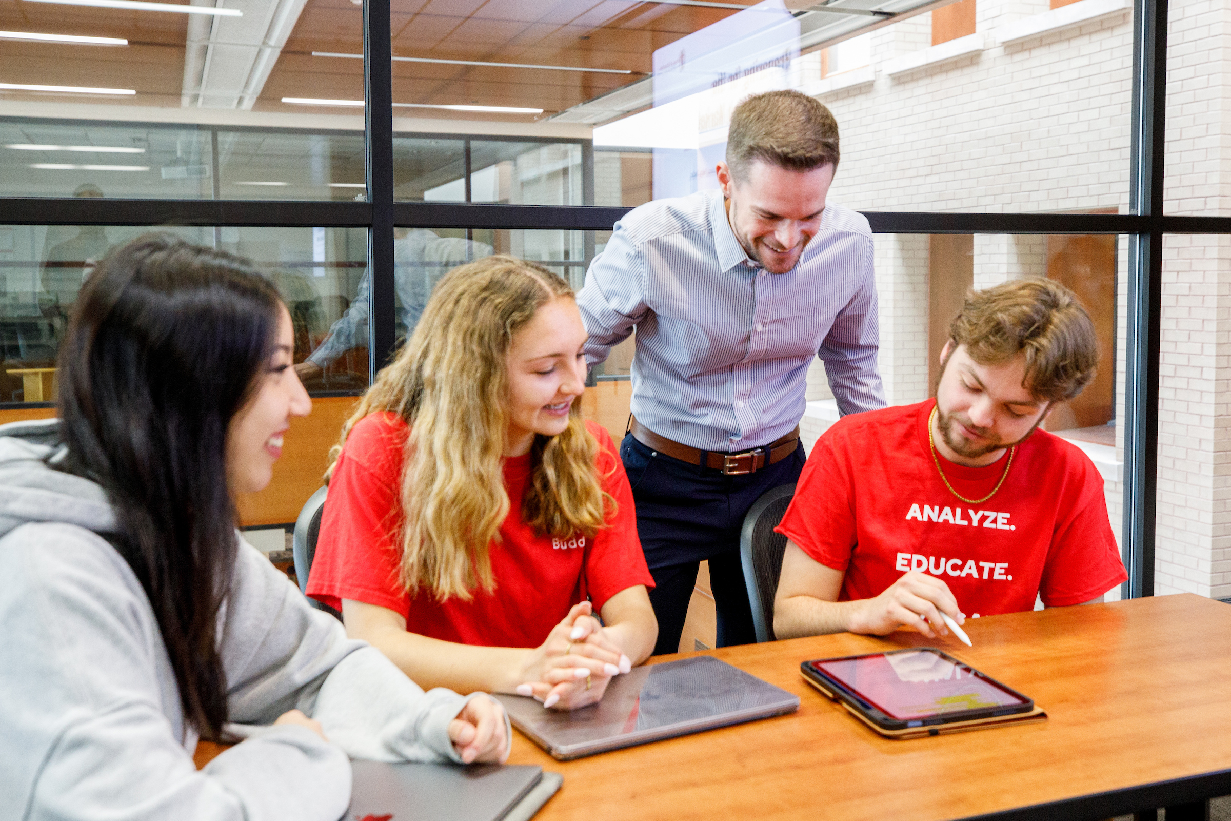 a professor works with college students