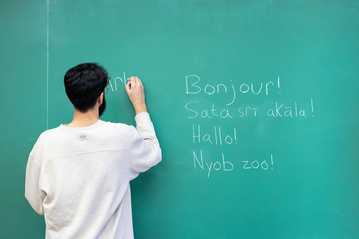 a person writing on a chalk board