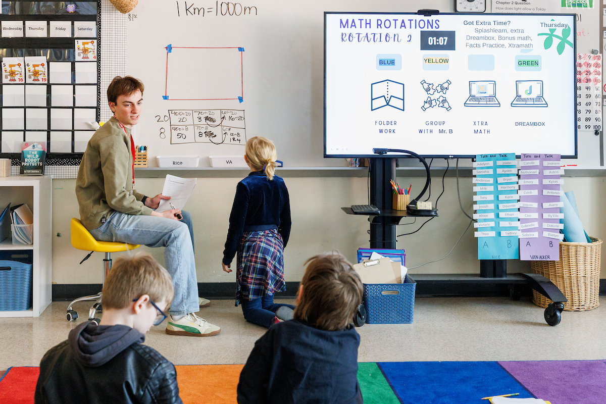 an elementary school teacher working with a student