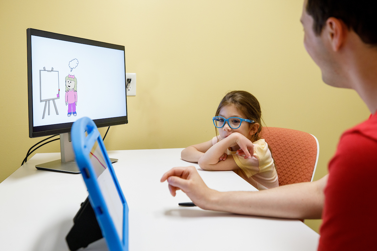 researcher working with a young child