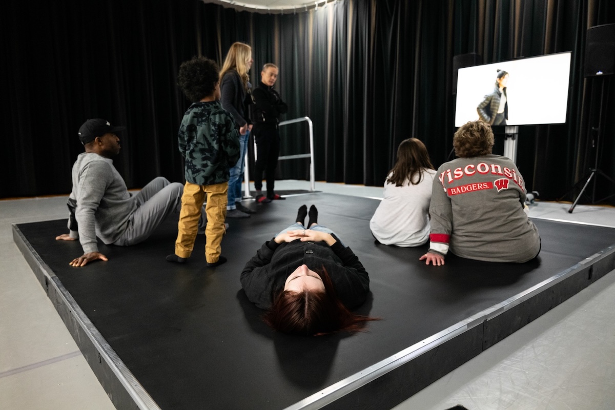 Viewers sit, stand, or lie down on a 12-by-12-foot platform to experience Omari Carter’s “Our Vibes: A Vibrotactile Screendance Installation.”