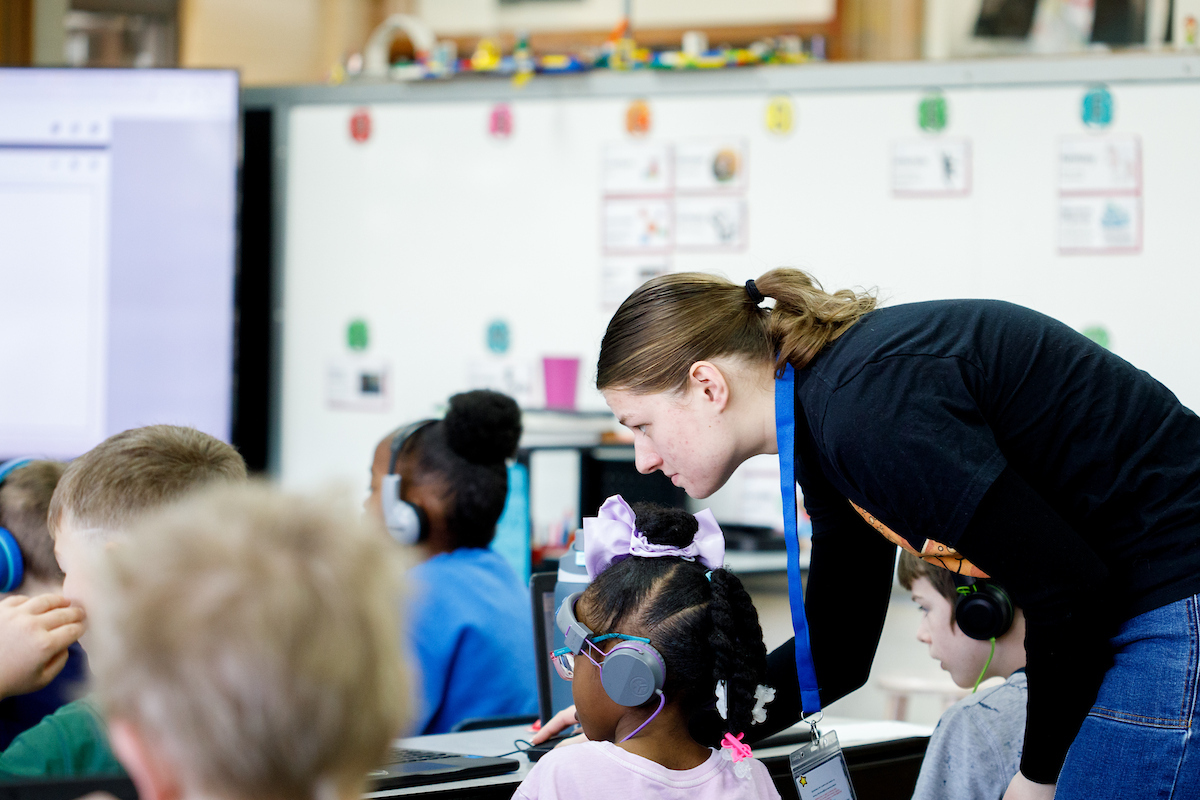 a teacher helping an elementary aged student