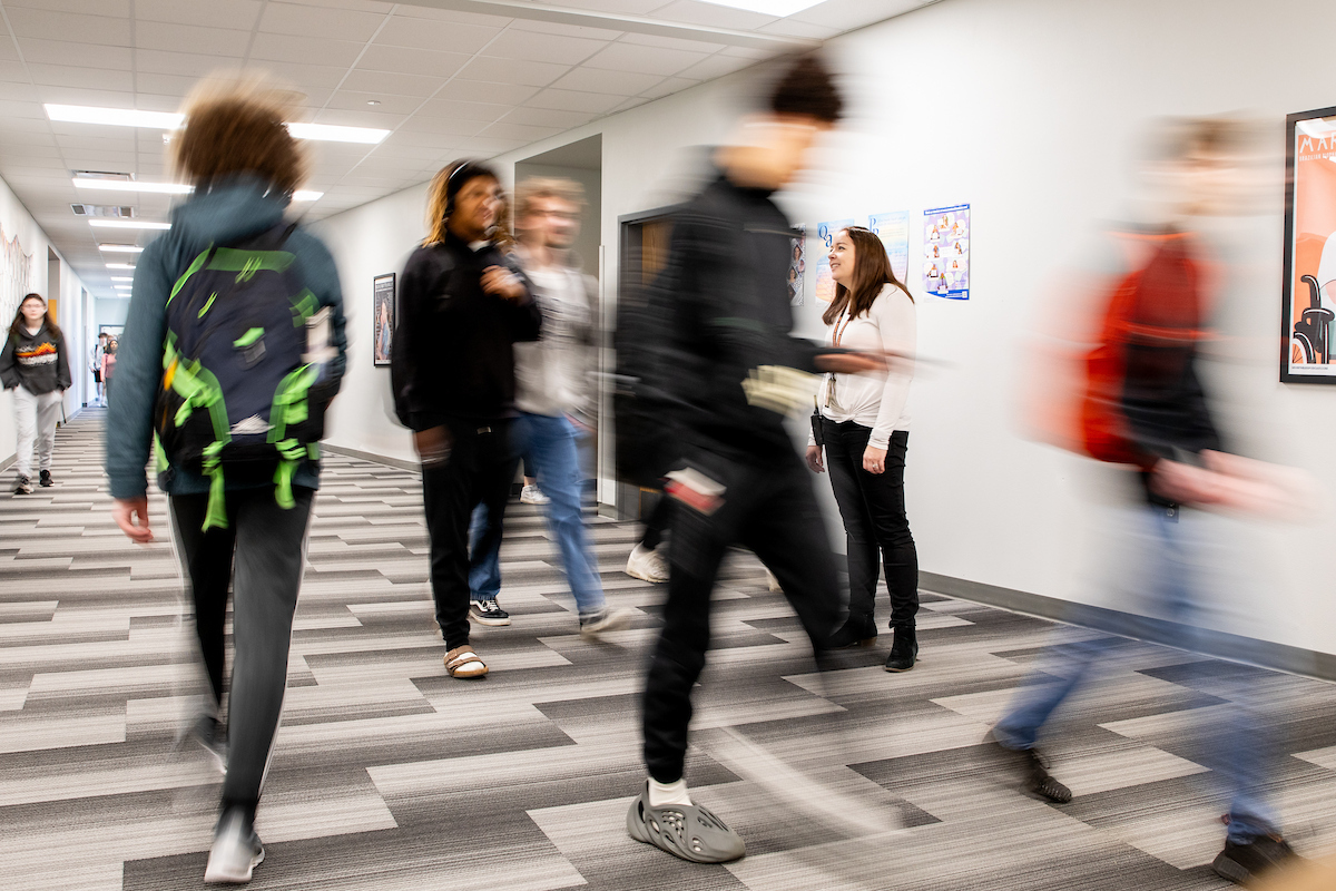 high school students walking in the halls