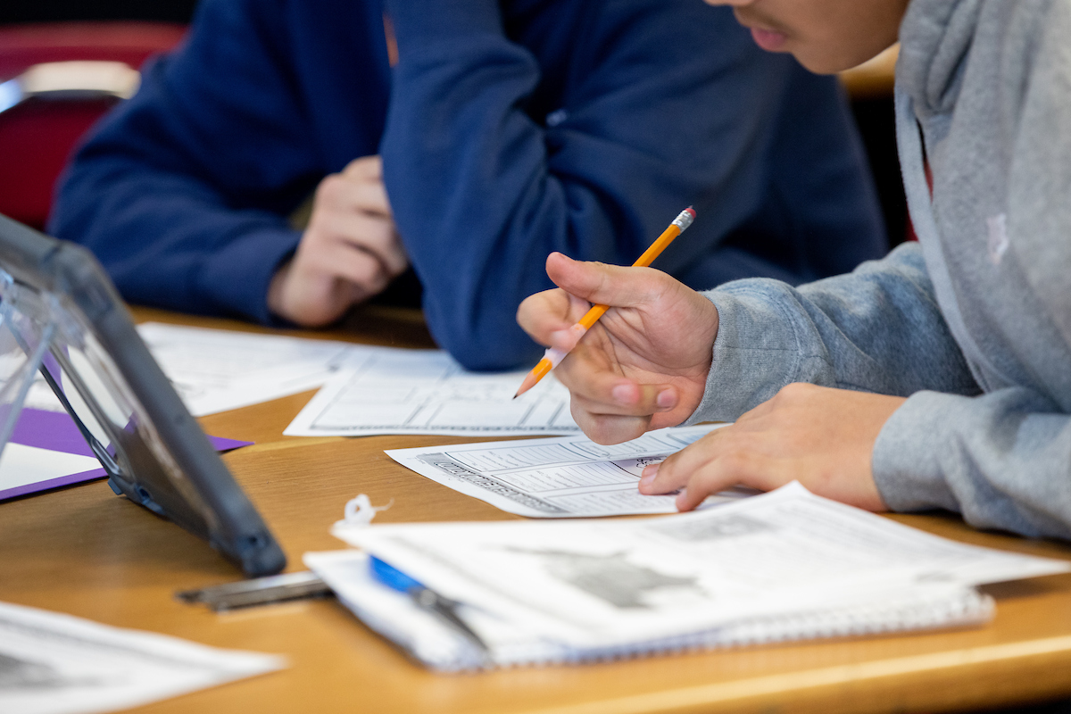 a middle school student working on a paper