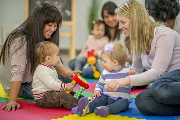 Infants and parents playing