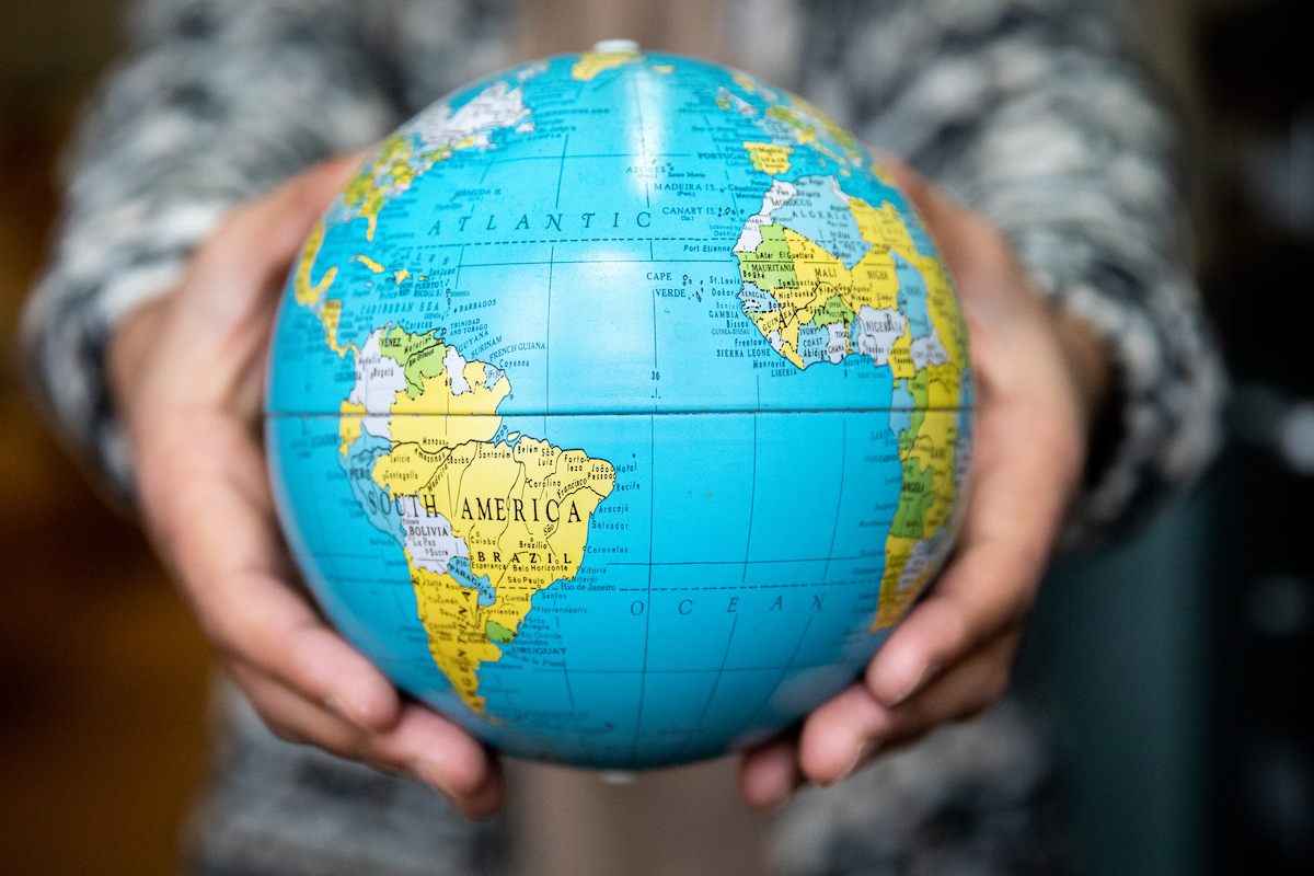 a person holding a globe