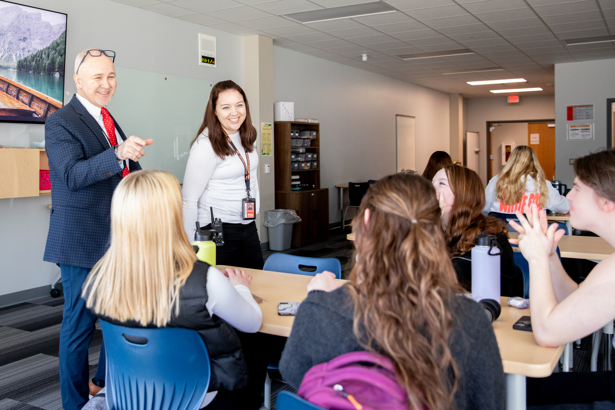 High School principal talking with students.