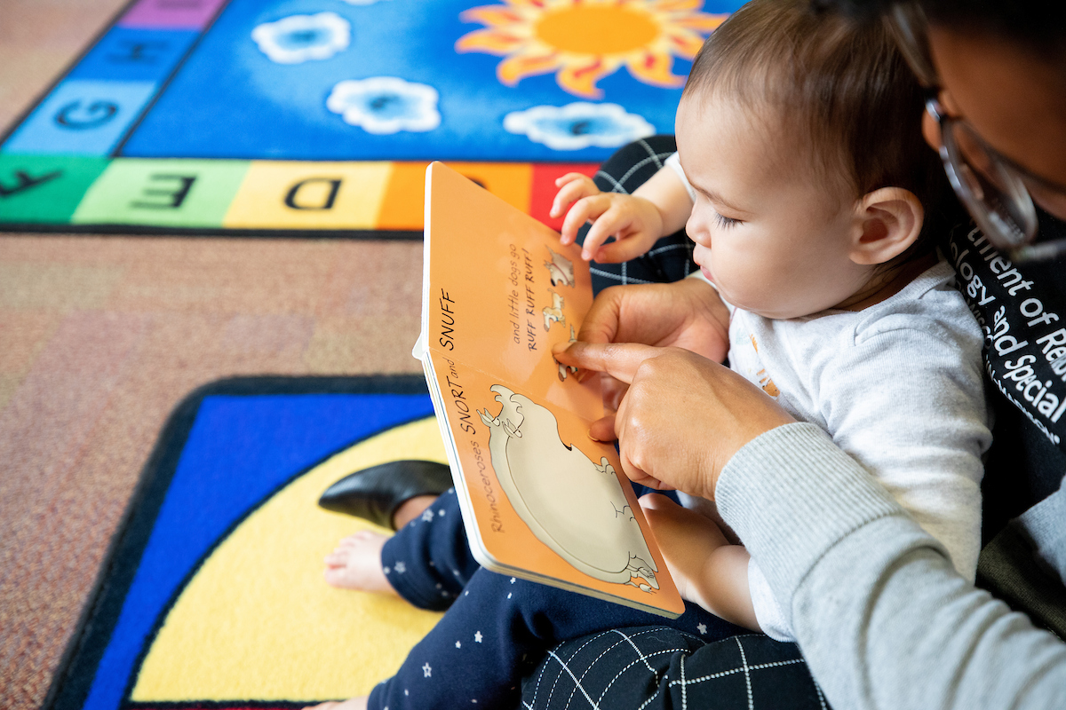 a small child being read to