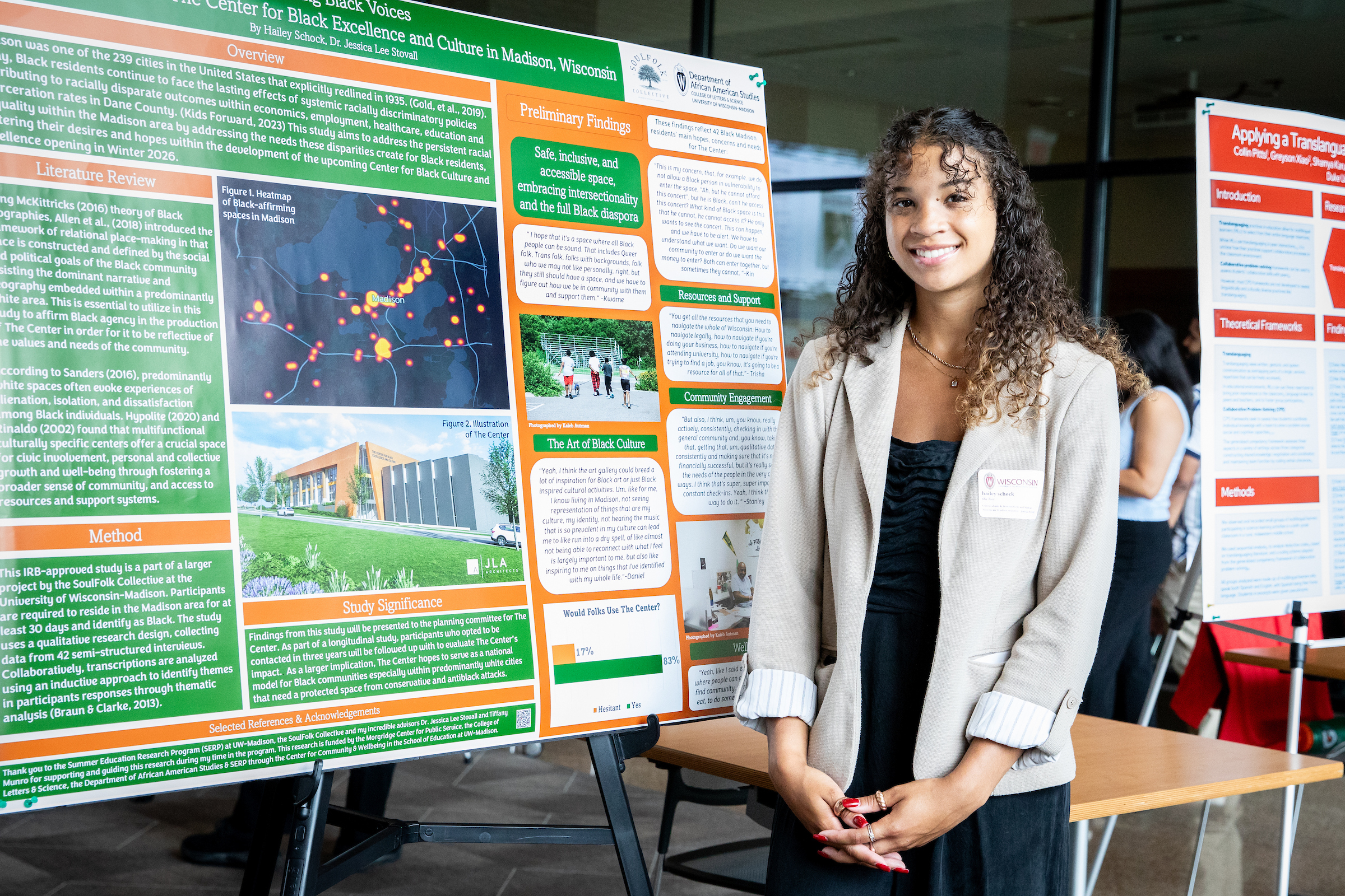 Hailey Schock stands in front of a SERP research poster.