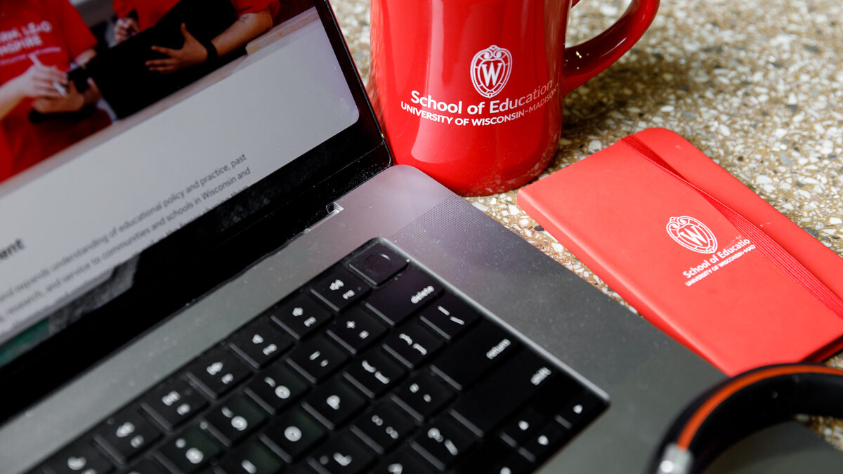 laptop, coffee cup, and notebook