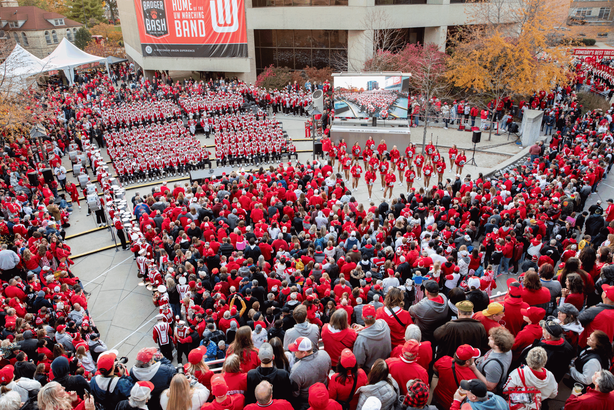 University of Wisconsin Marching band performs at the Homecoming Tailgate to a full crowd of badger fans