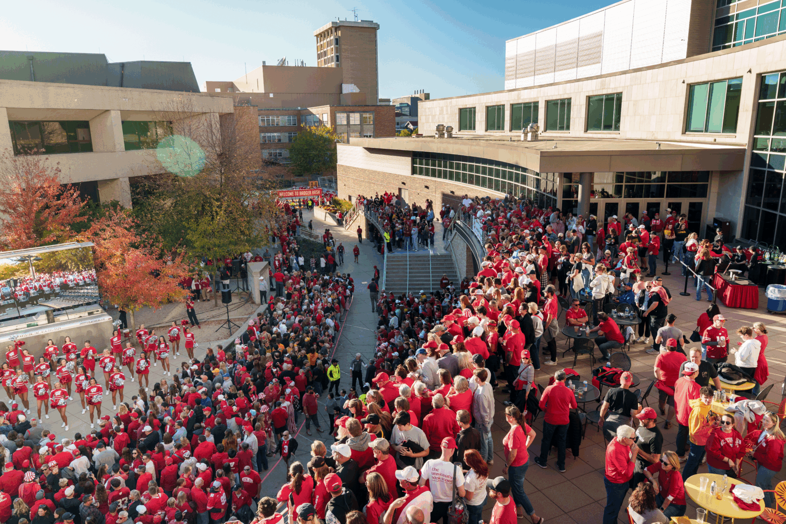Large group of people watching the UW band at the homecoming tailgate