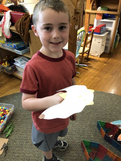 A boy learns about distributed weight in MMSD's 4K program at New Morning Nursing School in Madison.