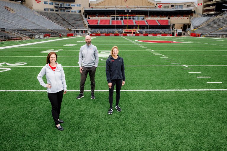 The three BIOS leaders stand on a football field
