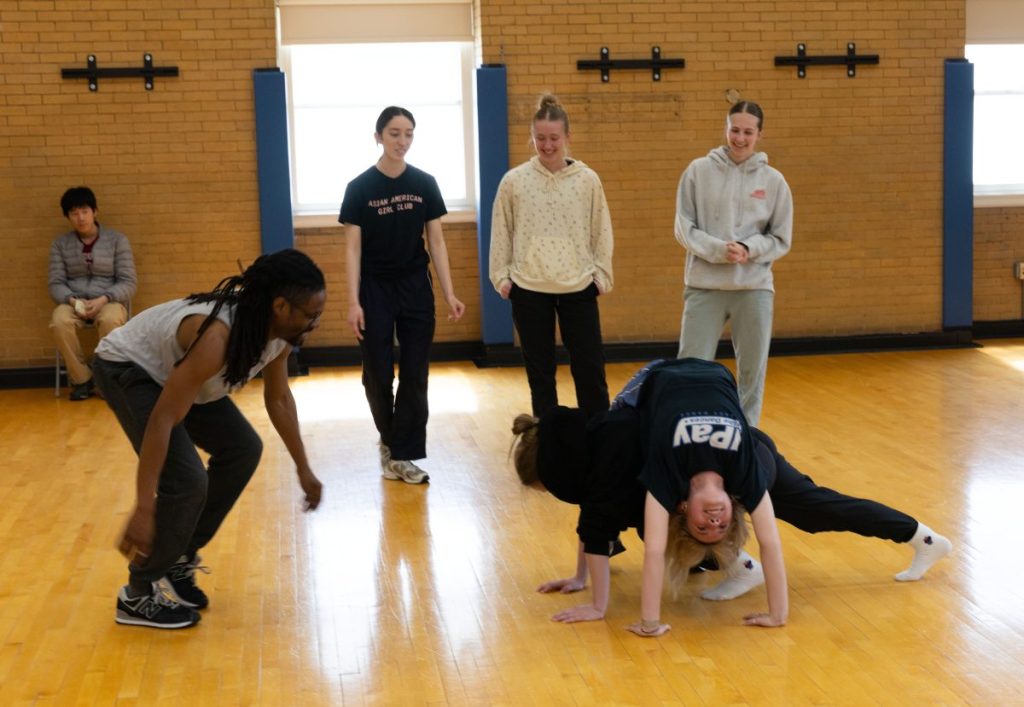 Omari Carter teaches a partner move to a group of students in his Dance 115: Hip-Hop Dance Technique and Theory class.