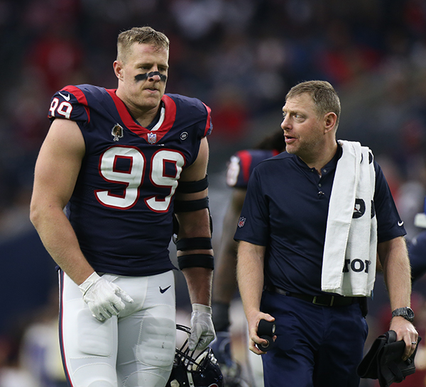 Geoff Kaplan walking alongside Houston Texans football player