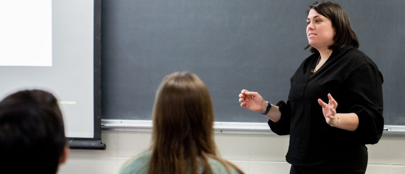 Professor at front of the class teaching students