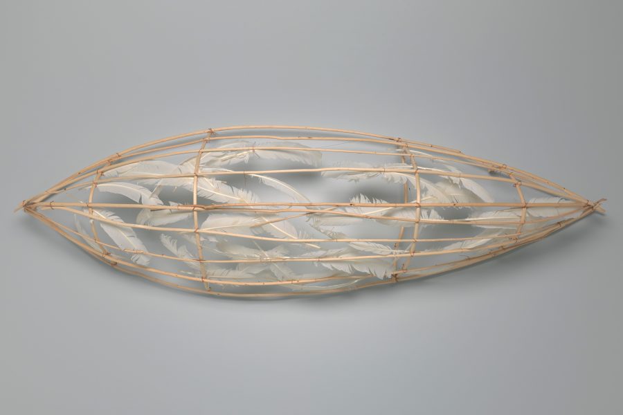 Art piece of a canoe made of feathers and copper wire