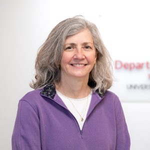 a woman smiles at the camera