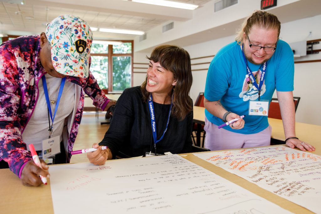 three people work at a table