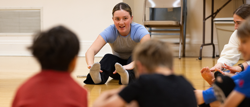Teacher showing students how to stretch