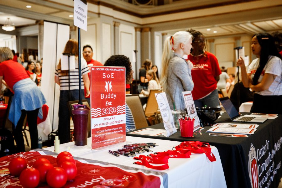 a table at an event promoting student organizations with college students